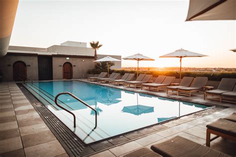 Lounge Chairs With Umbrella Near Swimming Pool · Free Stock Photo