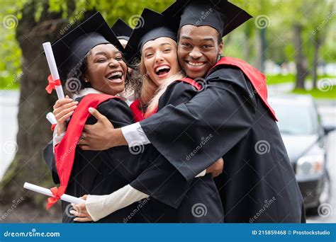 Black Guy and Two Young Ladies in Graduation Costumes Stock Photo ...