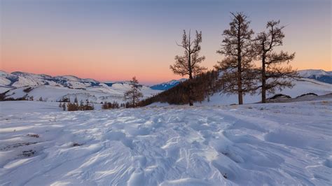 Snowy mountain landscape on the background of a beautiful sunset ...