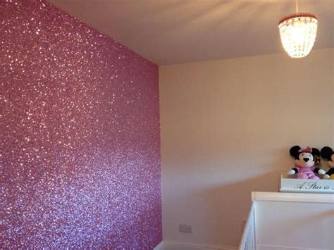 there is a pink wall with glitter on it and a minnie mouse stuffed ...