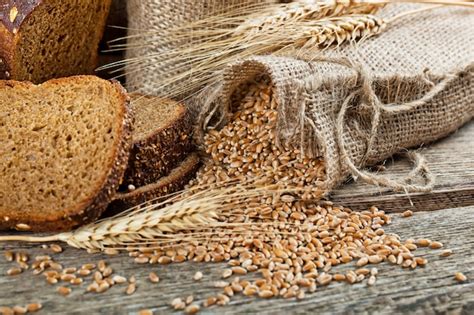 Premium Photo | Bread and wheat on a wooden background