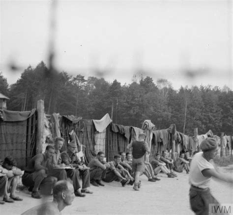 an old black and white photo of men playing baseball in front of some ...