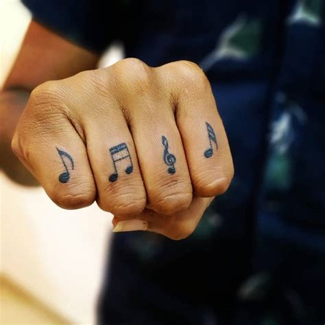 Aggregate more than 71 music note hand tattoo latest - in.cdgdbentre