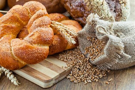 Premium Photo | Bread and wheat on a wooden background