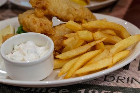 Premium Photo | Fish and chips with white sauce