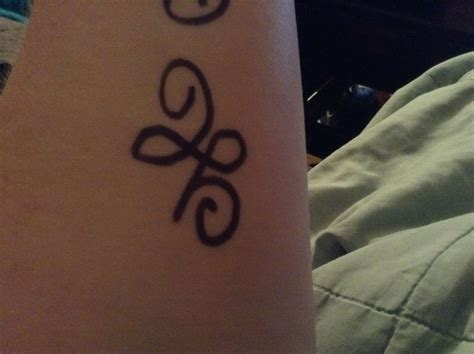 a close up of a person's arm with a tattoo design on the wrist