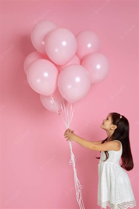 Premium Photo | Happy cute little child girl posing with pastel pink ...