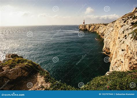 Jagged Cliff Towering Alongside Massive Ocean Stock Photo - Image of ...