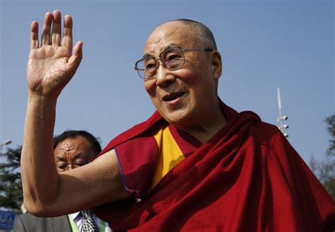 Tibetan spiritual leader the Dalai Lama waves to devotees outside the ...