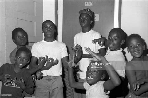 Young boys and members of the Grape Street Crip "throwing" their...