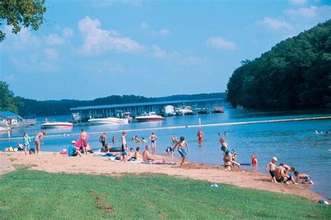 People playing and swimming at a beach on a lake Ha Ha Tonka, Kid ...