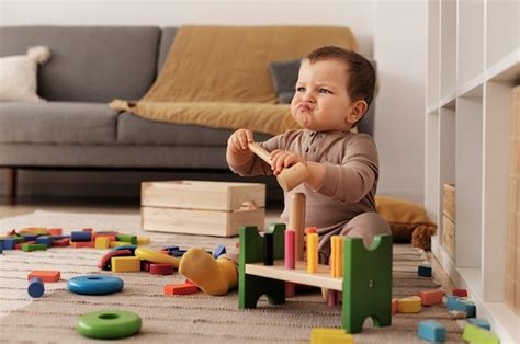 Premium Photo | Full shot upset kid with wooden toys