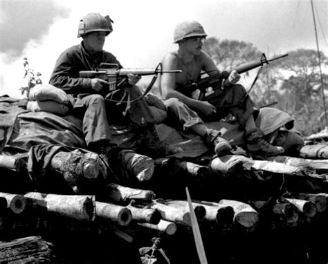 Soldiers of the US Army 4th Infantry Division sit on top of a bunker at ...