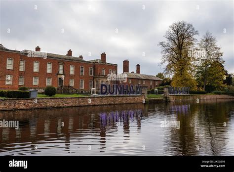 Dunham Massey Hall and Gardens reflecting in the lake with an ...