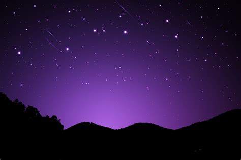 Night landscape with silhouettes of mountains and sky with stars ...