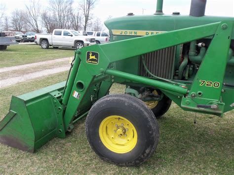 On the front of the John Deere 4020 is a large durable 720 loader ...