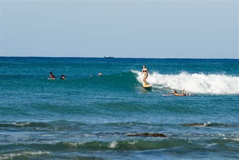 Free Stock photo of Woman surfing on Waikiki Beach | Photoeverywhere