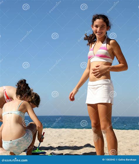 Girls on the beach stock photo. Image of friends, play - 1582042