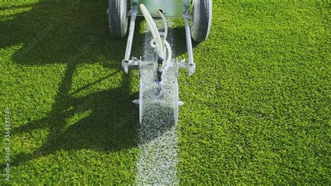 Marking football stadium field using a professional paint machine Stock ...