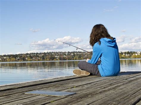 Girl Fishing Off Dock Stock Image - Image: 24347001