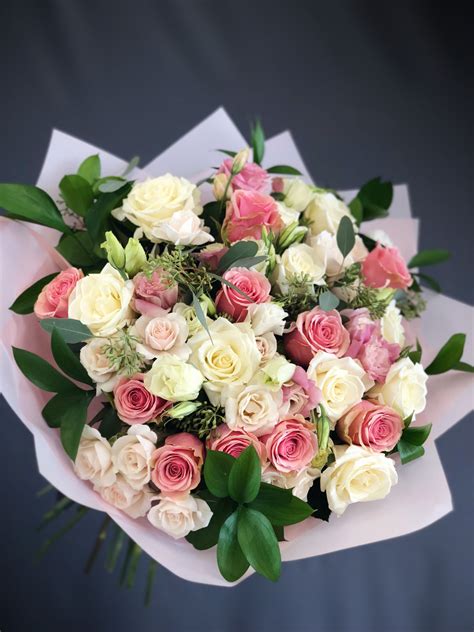 a bouquet of white, pink and green flowers