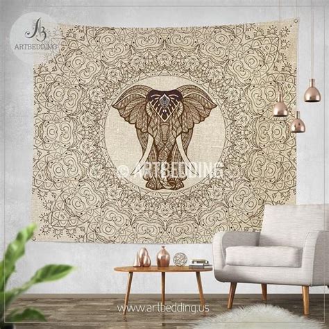 an elephant tapestry hanging on the wall in a living room with a chair ...