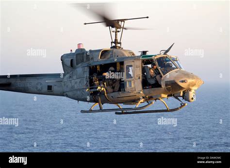 A US Marine Corps UH-1N Iroquois helicopter prepares to land aboard ...