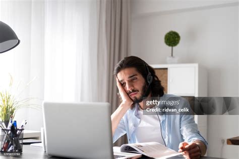 Young Man Studying And Working On Laptop At Home High-Res Stock Photo ...