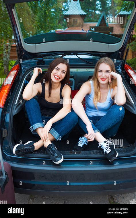 Two girls posing in car Stock Photo - Alamy