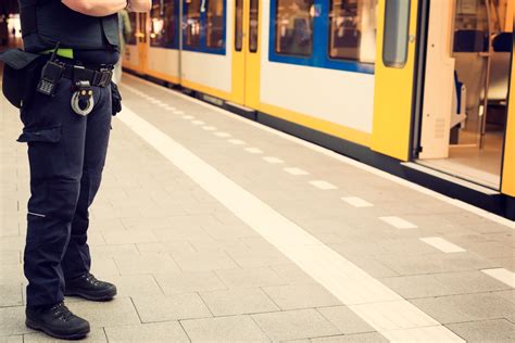 Police officer guarding a train station to prevent terrorist attacks ...