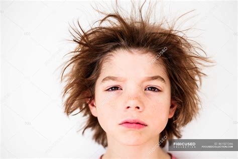 Portrait of a boy with messy hair — close up, serious - Stock Photo ...