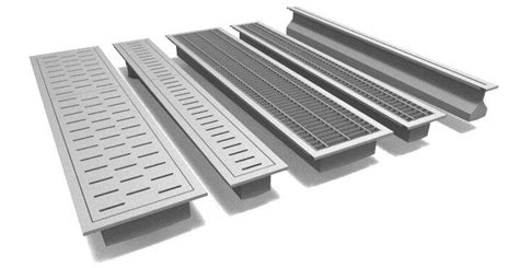 several metal grates are lined up on a white surface