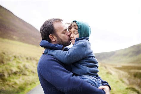 UK, Bala, father and son hugging each other stock photo