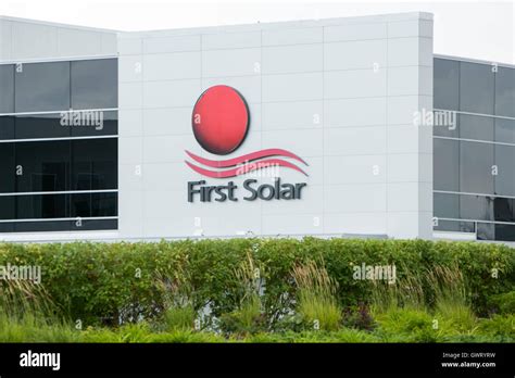 A logo sign outside of a facility occupied by First Solar in Perrysburg ...