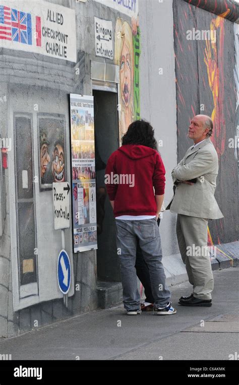 John Malkovich and his family visit the 'Eastside Gallery', the remains ...