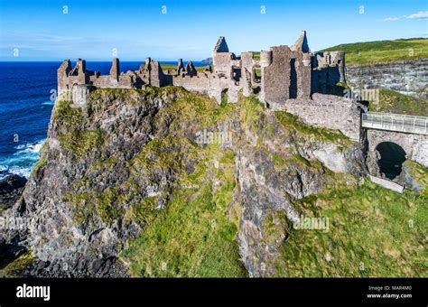 Ruins of medieval Dunluce Castle, cliffs, bays and peninsulas. Northern ...