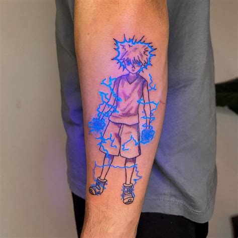 UV ink Killua tattoo located on the forearm, cartoon