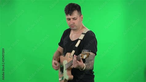 Portrait professional musician playing the electric guitar. Young guy ...