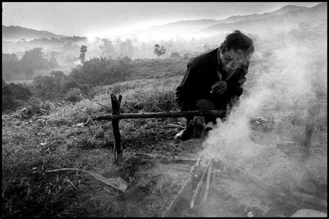 Paul Fusco- An old squatter hunches over a breakfast fire. | Magnum ...