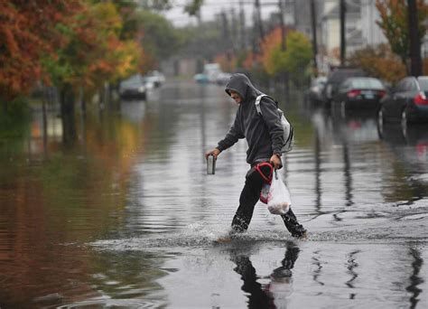 Heavy rains, falling leaves flood city streets