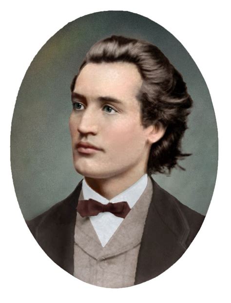 an old photo of a young man in a suit and bow tie, looking to the side