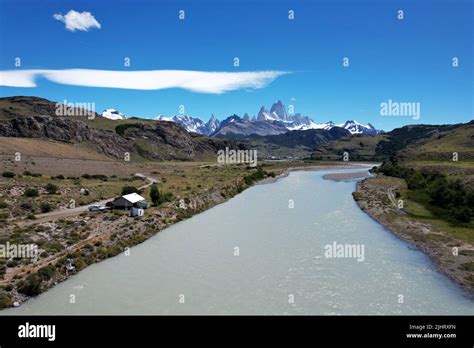 An aerial view of Fitz Roy mountain, with blue sky and river, Patagonia ...