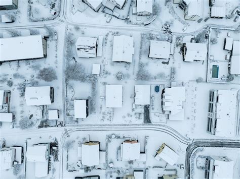 Premium Photo | Aerial view of town with snow covered houses. roof tops ...