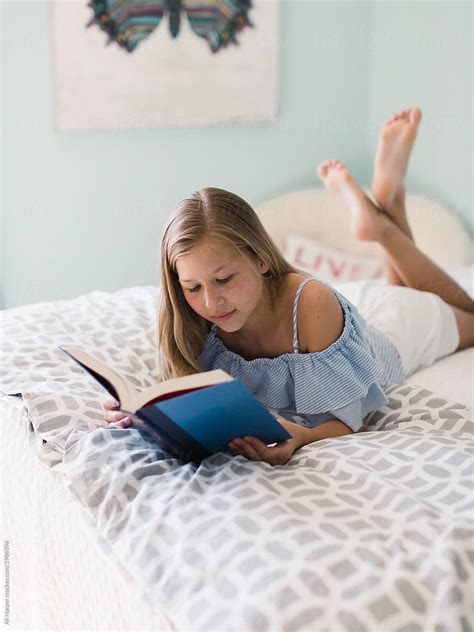 "Young Girl Reading On Her Bed" by Stocksy Contributor "Ali Harper ...