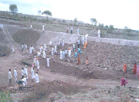 Stone Pitching on the face of the earthen bund of a percolation tank ...