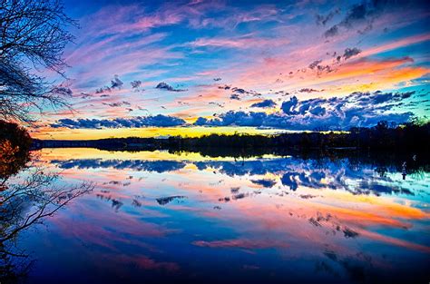 Sunset And Reflection With Beautiful Sky Rainbow Colors Photograph by ...