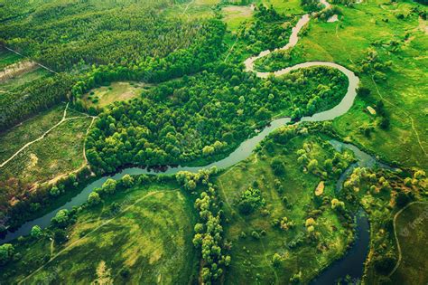 Premium Photo | Aerial landscape of winding river in green field, top ...