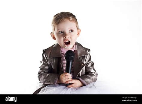 Portrait of a toddler girl singing in microphone Stock Photo - Alamy