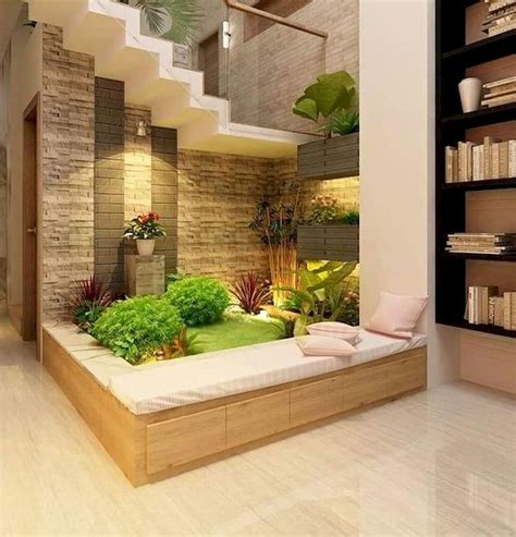 the interior of a modern house with plants and bookshelves on either ...