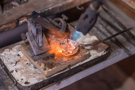 Melting Process of Precious Metal Gold Behind a Jeweler`s Workbench ...